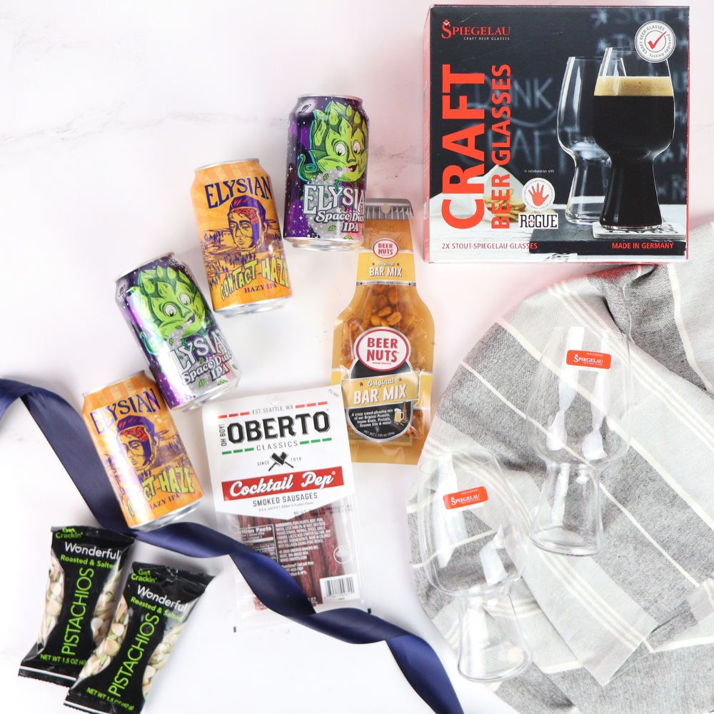 Assorted snacks and beer-related items including cans, a box of glasses, and a bag of chips on a white background.